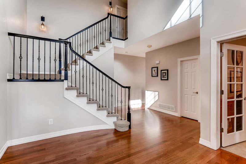 Foyer and staircase with greige walls and white trim